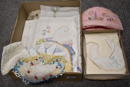 A selection of embroidery and lace worked items including doilies and a table cloth.