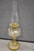 A Victorian oil lamp having cut glass well with brass column base.