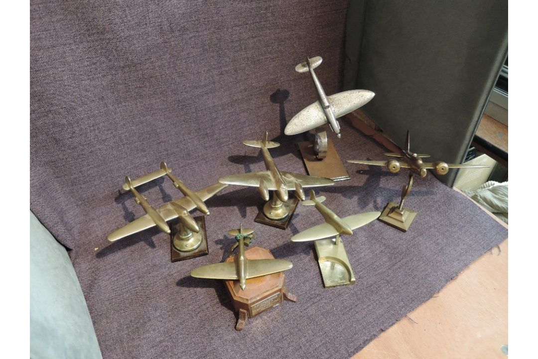 Seven brass or chrome model Aeroplanes on stands, all WW2 Fighters or Bombers