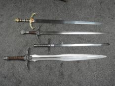 Four modern Medieval Swords, one having spear shaped blade with script and highly decorated