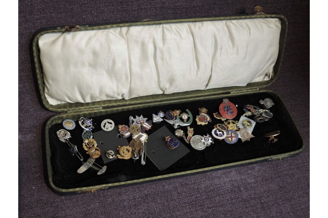 A collection of Badges and Sweetheart Brooches, mainly Military in a folding case