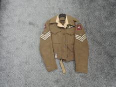 A British Army Battle Blouse with earlier Glider Pilot Badges including Wings, Glider Pilot Regt,