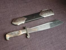 A German WW2 RAD (Reich Labour Service)Hewer 1934 having horn grip with eagle head, single edge