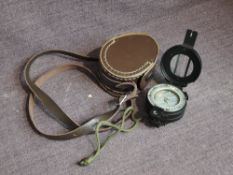 A Francis Barker M73 Military Compass having military marks and leather case marked 83PG