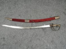 An Indian Hanger Sword having decorated curved blade, brass hilt and guard with animal head