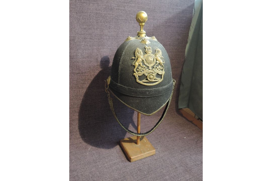 A late 19th/early 20th century Black Cloth Royal Artillery Helmet having brass bowl top crown, brass