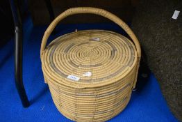 A vintage wicker basket with lid.