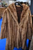 A vintage mink coat, medium to large size.