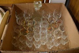 A pressed glass decanter and a selection of wine and spirit glasses.