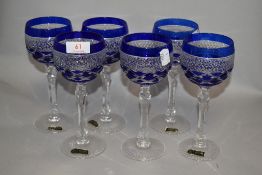 A set of six Hochwertiges Bleikristall wine glasses with blue glass overlay.