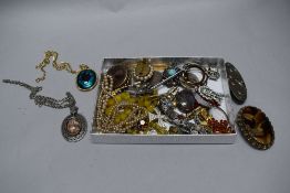 An Arts and Crafts style pewter brooch with similar agate brooches and costume jewellery