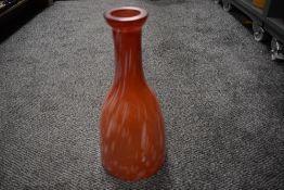 A Romanian art glass vase having mottled red and white finish.