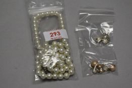 A simulated pearl necklace with two bracelets and a pair of earrings.