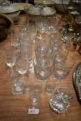 A mixed lot of glass, including vintage etched wine glasses and tumblers.