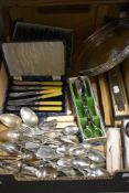 A selection of cutlery and flatwares including fruit knives and serving wares.