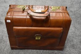 A modern tan leather briefcase with compartmental inner in good quality. Lockable with key codes.