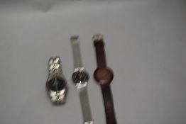Two modern replica wristwatches bearing name Rolex with a Tissot wristwatch.