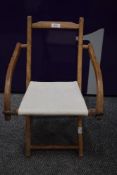 An early 20th century Childs fold away camping chair.