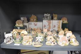 A selection of vintage Lilliput lane model houses and cottages, some having original boxes.