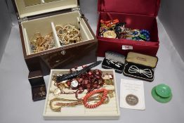 Two jewellery cases with contents including necklaces, curios and trinkets, bracelets and earrings.