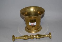 A 18th century apothecary or similar mortar and pestle, mortar of traditional fluted bell form