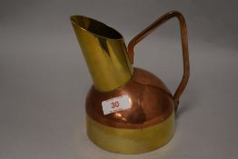 An early 20th century trench art style water jug in heavy copper and brass design.