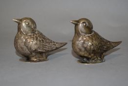 A pair of salt and pepper pots in white metal in the form of birds, one with broken hinge.