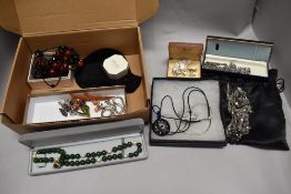 A selection of boxed costume jewellery including necklaces, cufflinks and a bakelite bird brooch.