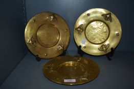 Three small antique Arts and Crafts brass plates.