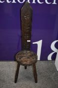 A reproduction spinning chair in oak with turned legs and carved back.