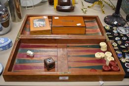 An early 20th century Backgammon games compendium with bridge cards and counter tokens.