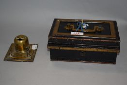A early 20th century brass inkwell with pen rest and small lockable strong box with key.