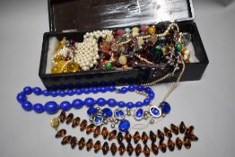 An early 20th century Japan Lacquer glove box with a selection of costume jewellery.