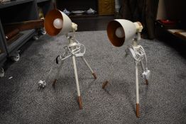 A pair of modern tripod footed lamps.