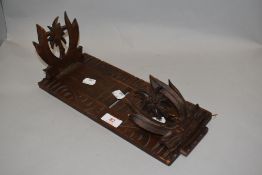 A vintage softwood slide fold out book shelf wooden carved with decorated ends.
