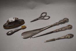 A HM silver manicure and dressing set including toothbrush, buffer, shoe horn, scissors, button hook