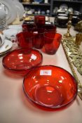 A selection of vintage Cranberry glass wares including two Whitefriars style dishes.