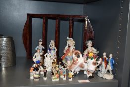 A selection of miniature ceramic figure studies including Hansi and two Capodimonte figures.