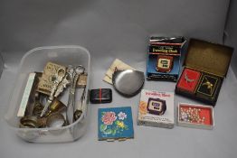 A selection of curios and trinkets including napkin rings, sovereign case and a Ronson cigarette