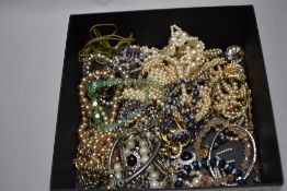 A collection of assorted simulated pearl necklaces.
