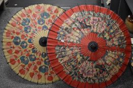 Two 20th century oriental parasol with hand painted floral designs.