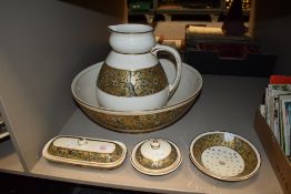 An early 20th century Doulton wash jug chamber pot and bowl set with cream ground and gilt floral