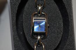 A ladies DKNY wristwatch with blue rectangular dial, sold with branded frosted plastic box