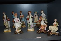 A collection of vintage Capodimonte figure and figurine studies including pairs of musicians,
