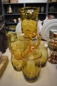 A vintage Thomas Webb English Bullseye style yellow glass vase with a water jug and three glasses.