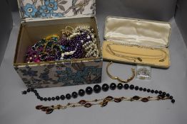 A selection of costume jewellery including necklaces and simulated pearls.