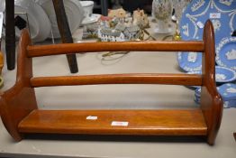 A mid century Teak book shelf with stylised shape.