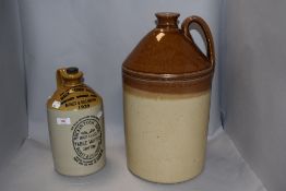 An early 20th century Mackintosh bros advertising flagon with a similar larger stone ware flagon.