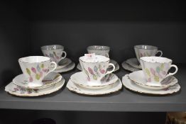 A set of six vintage hand painted porcelain tea cup and saucer trios.