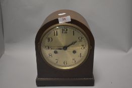 An Edwardian oak cased bracket style mantel clock with chime.